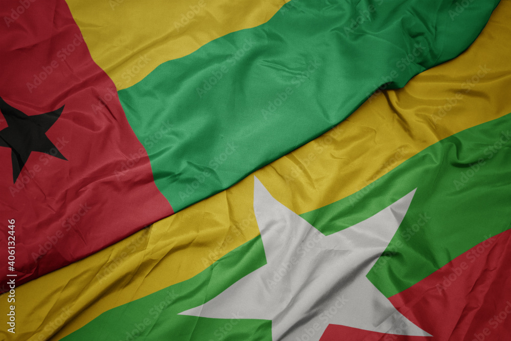 waving colorful flag of myanmar and national flag of guinea bissau. waving colorful flag of myanmar and national flag of guinea bissau.