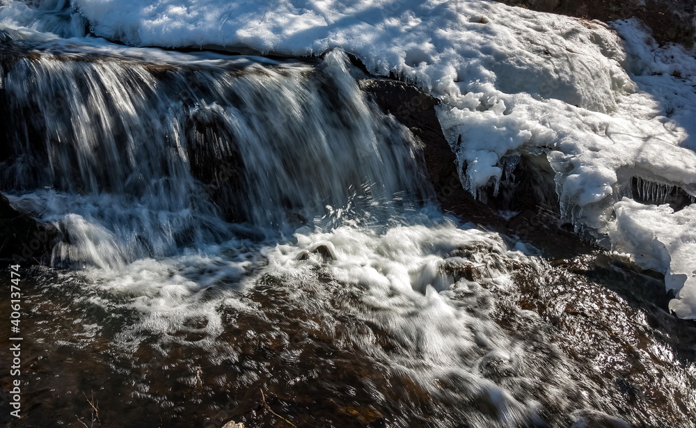 A small waterfall on the river in the spring A small waterfall on the river in the spring
