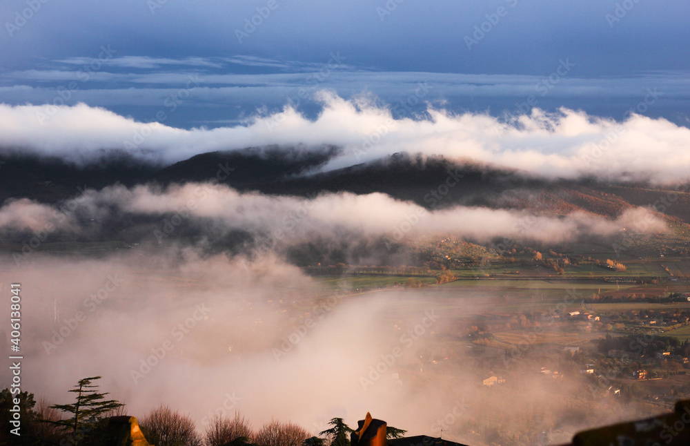 Incredible landscape and sunset with fog over the Val d'Orcia in Tuscany, Cortona 
