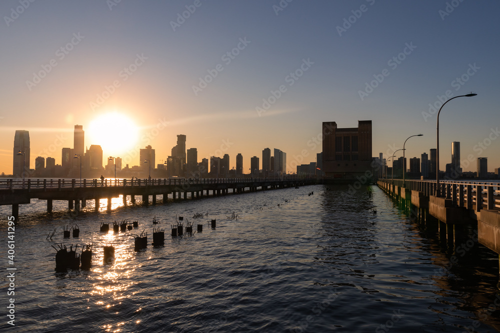 Pier 34 along the Hudson River in New York City with a Sunset over the Jersey City Skyline