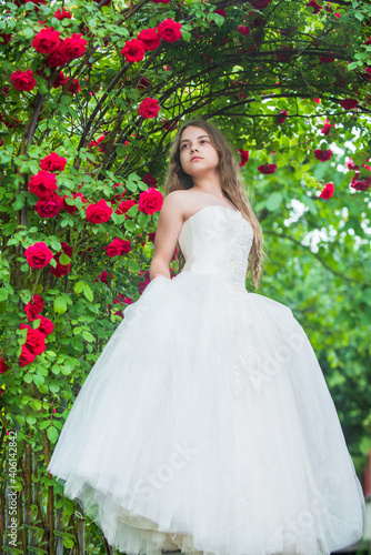 Dreamy girl ballroom dress in rose garden, rosarium concept