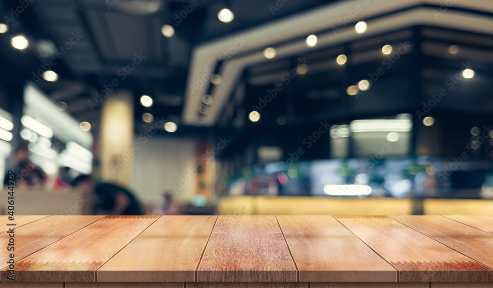 Empty wooden table top with lights bokeh on blur restaurant background. Empty wooden table top with lights bokeh on blur restaurant background.