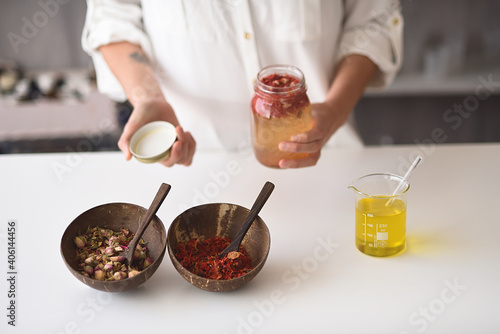 Woman with natural cosmetic ingredients to make elixir