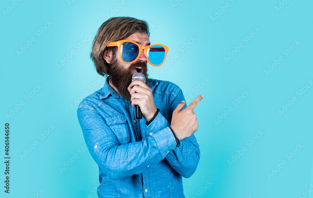just look at this. vocal school. favorite music style. concept of music. performer having fun. mature bearded man in funny party glasses sing song. brutal male hipster with microphone just look at this. vocal school. favorite music style. concept of music. performer having fun. mature bearded man in funny party glasses sing song. brutal male hipster with microphone