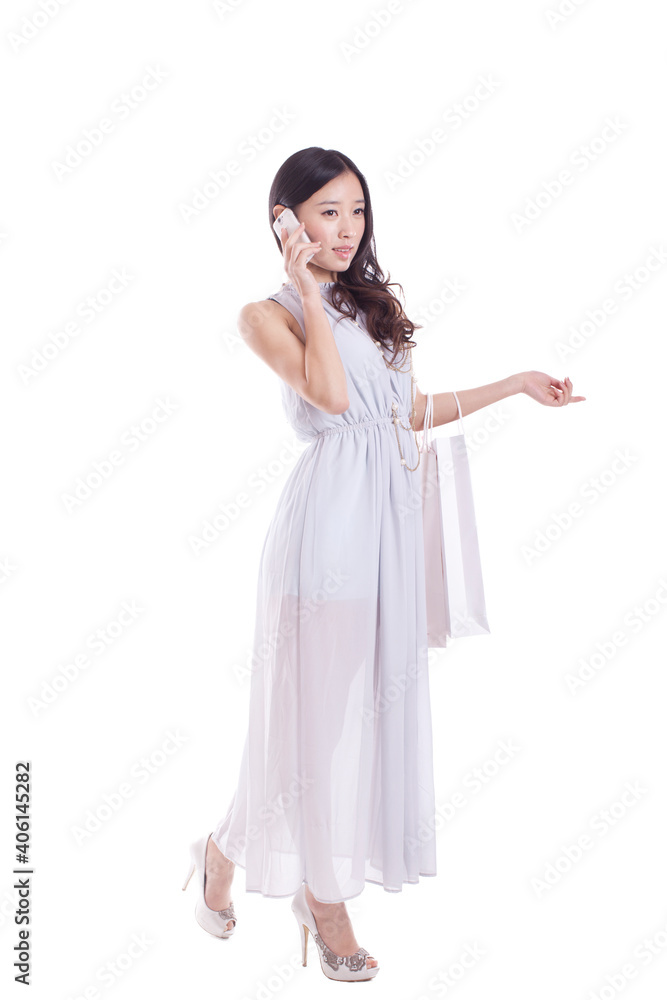Young woman carrying shopping bags,using cell phone Young woman carrying shopping bags,using cell phone
