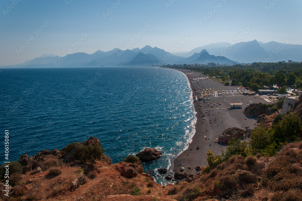 Aerial view of beautiful blue gulf and long Konyaalti beach in Antalya, Turkey. Antalya is Turkey's biggest international sea resort located on Turkish Riviera.