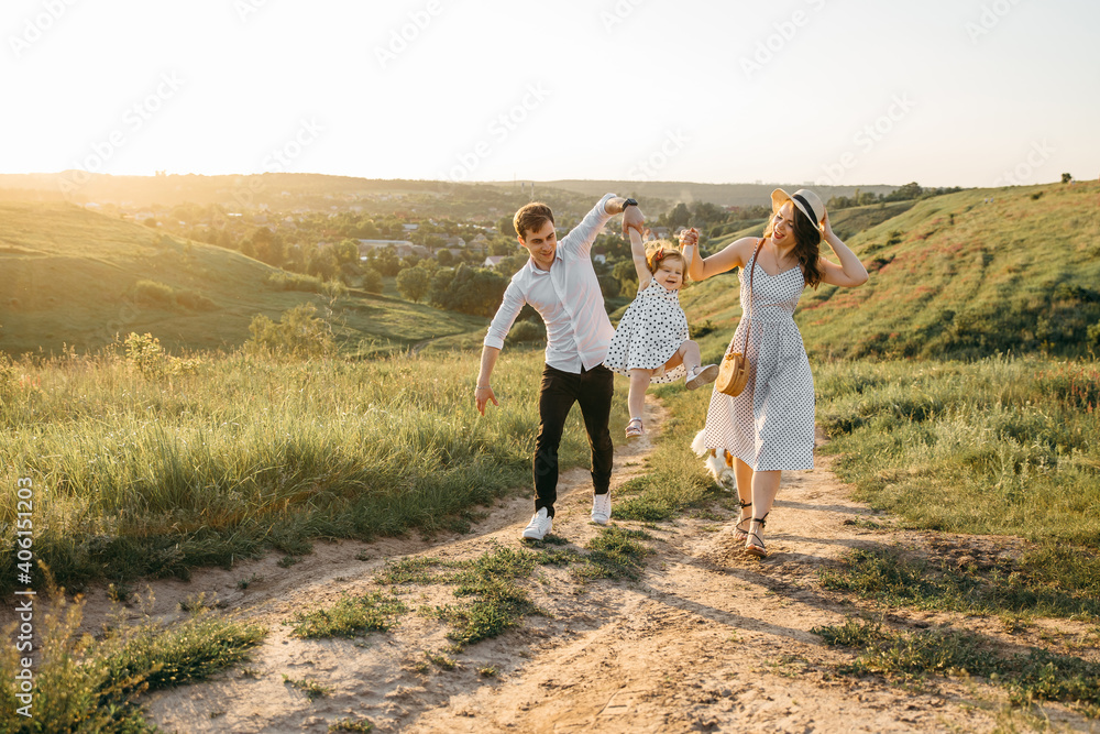 Happy family have fun in the mountains at sunset Happy family have fun in the mountains at sunset