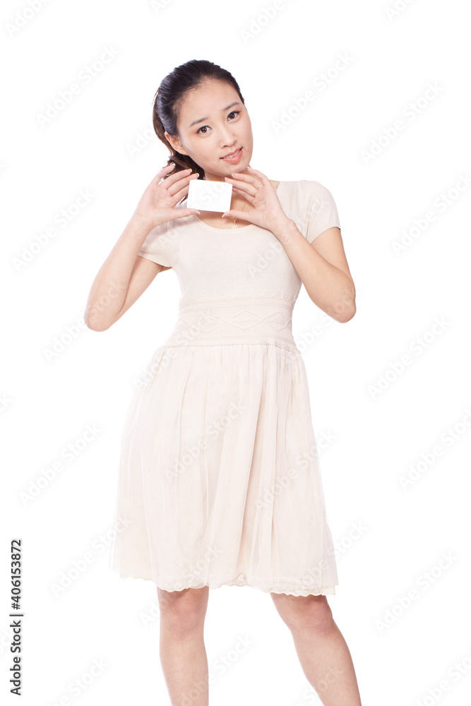 A Young woman standing,holding her cell phone A Young woman standing,holding her cell phone