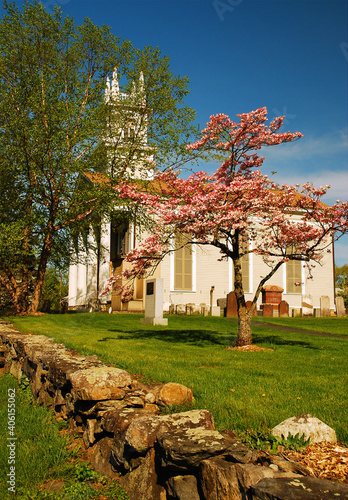 Flowers trees surround a pretty New England style church photo