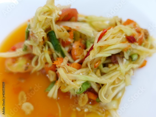 Thai food Somtam or papaya spicy salad on white dish