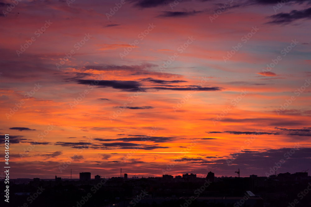 evening city landscape. silhouettes of buildings against a cloudy sky. bright colors panorama