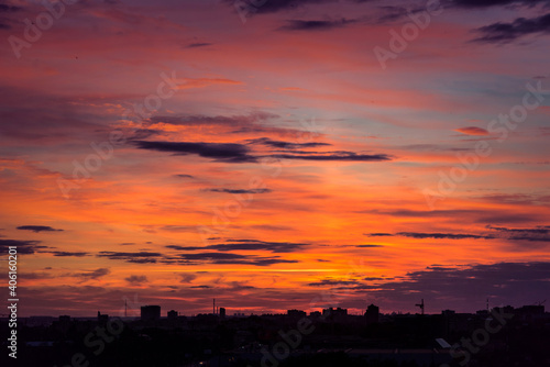 evening city landscape. silhouettes of buildings against a cloudy sky. bright colors panorama © Maya
