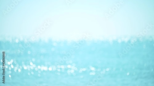 Abstract bokeh background from summer blue sea water at the beach photo