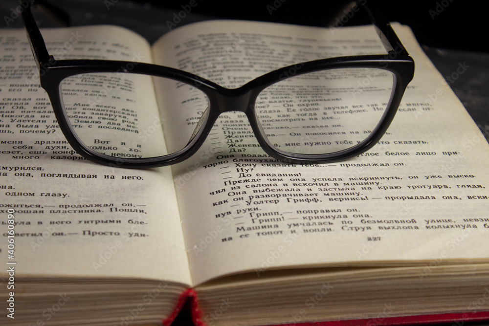 The glasses are on the book. Composition glasses and book The glasses are on the book. Composition glasses and book