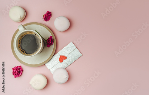 Cup of coffee and love letter on trending pink paper.The concept of valentine's day and women's day.Flat lay, top view with copy space.
