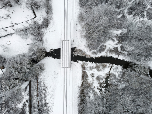 Wallpaper Mural aerial view of winter landscape with railway crossing the river covered with snow. drone photography. top view Torontodigital.ca