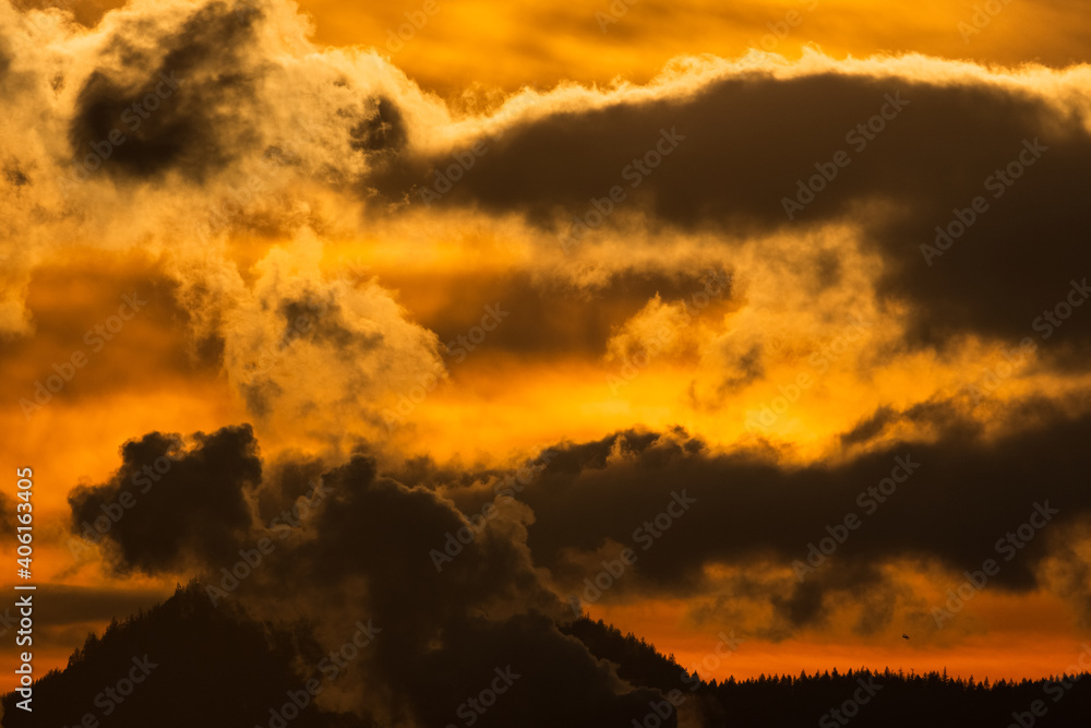 Panorama dramatic sunrise or sunset sky with dark clouds and landscape with mountain and trees