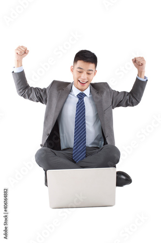 Portrait of young bisinessman sitting in the front of laptop  photo