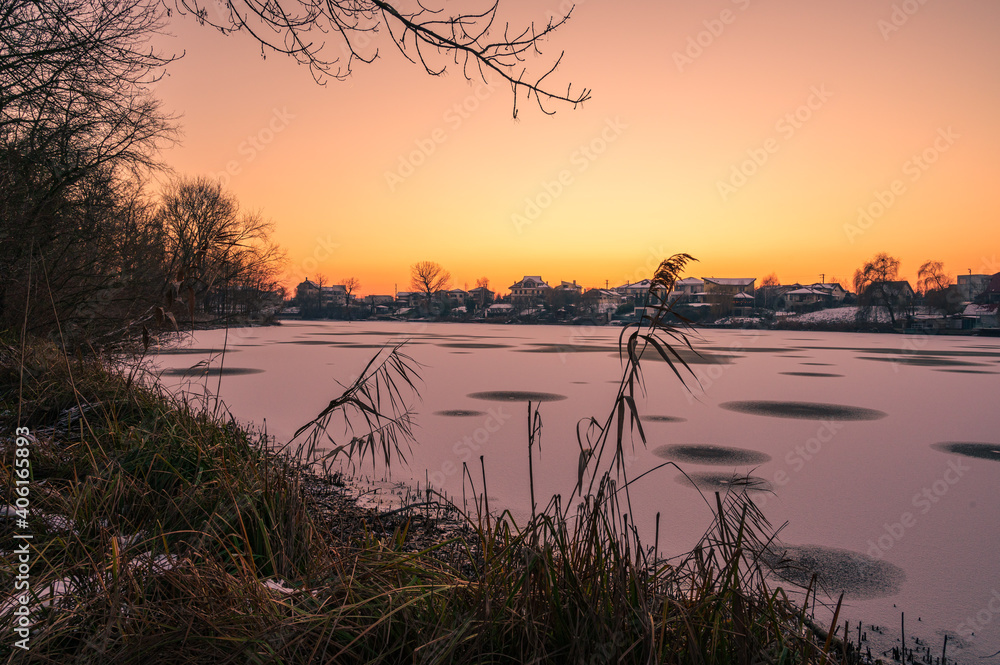 Sunset over frozen lake