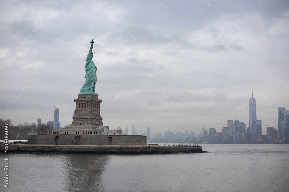 The statue of Liberty with World Trade Center background and Manhattan, New York City, USA