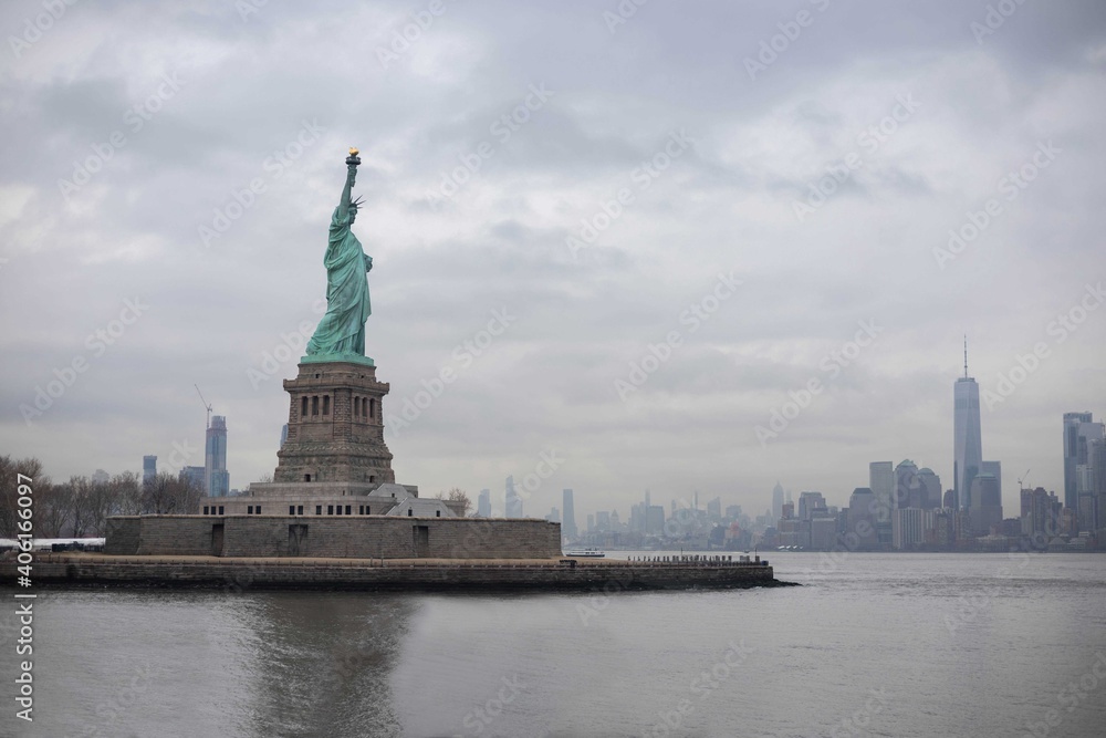 The statue of Liberty with World Trade Center background and Manhattan, New York City, USA The statue of Liberty with World Trade Center background and Manhattan, New York City, USA