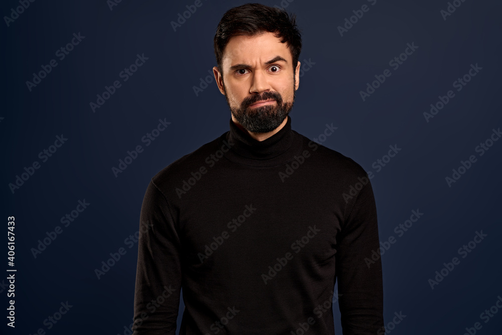 Freak-out shocked handsome bearded man, cringe from something disgusting or awful, grimacing alarmed, frowning make troubled, frustrated expression, standing worried over Pacific Blue background Freak-out shocked handsome bearded man, cringe from something disgusting or awful, grimacing alarmed, frowning make troubled, frustrated expression, standing worried over Pacific Blue background