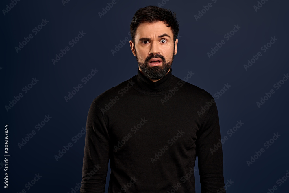 Freak-out shocked handsome bearded man, cringe from something disgusting or awful, grimacing alarmed, frowning make troubled, frustrated expression, standing worried over Pacific Blue background Freak-out shocked handsome bearded man, cringe from something disgusting or awful, grimacing alarmed, frowning make troubled, frustrated expression, standing worried over Pacific Blue background