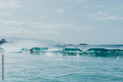 Boy surfing a wave in Hawaii