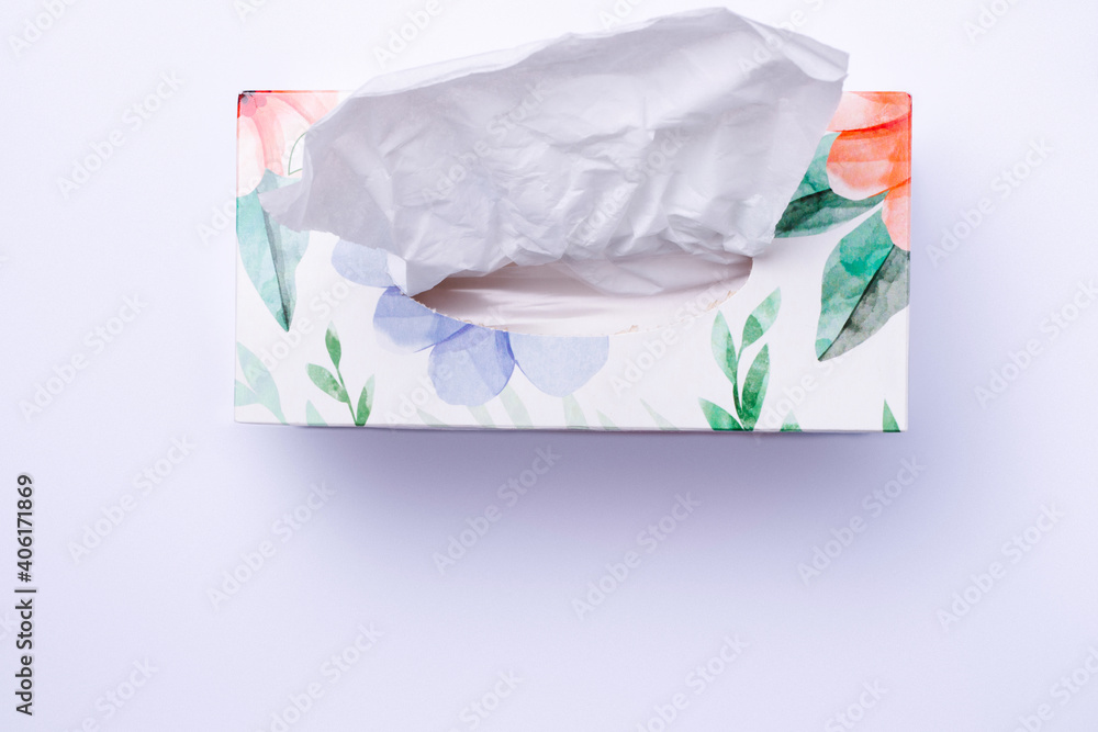 Colored box with disposable paper napkins on white background with bottom blank space. Colored box with disposable paper napkins on white background with bottom blank space.