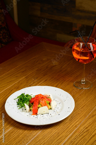 Vegetable vegetarian salad with tomatoes, peppers and onions on wooden table. photo