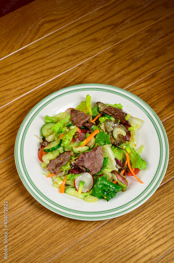 Fried meat with vegetables. Salad with meat, tomatoes, peppers, cucumbers and salad Fried meat with vegetables. Salad with meat, tomatoes, peppers, cucumbers and salad