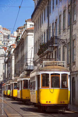 Many yellow tramways parked in one of the main streets of the city of Lisbon. Portugal.