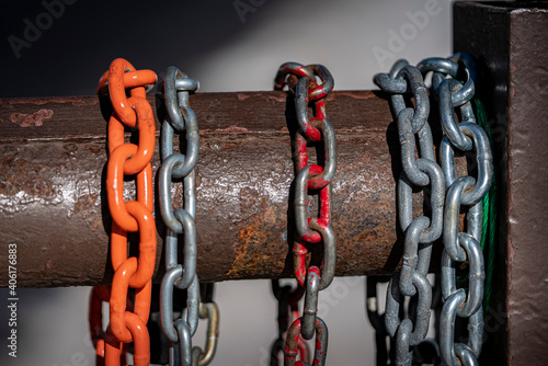 Valokuva Colorful chains hang on a rusted steel gate at a forest service road in the mountains