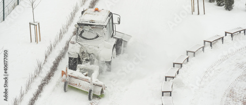 Tractor vehicle cleaning the yard from the snow storm