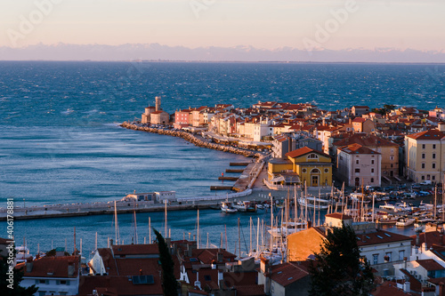 Piran  Picturesque seaside old  town in Slovenia against snow covered alps mountains in winter.