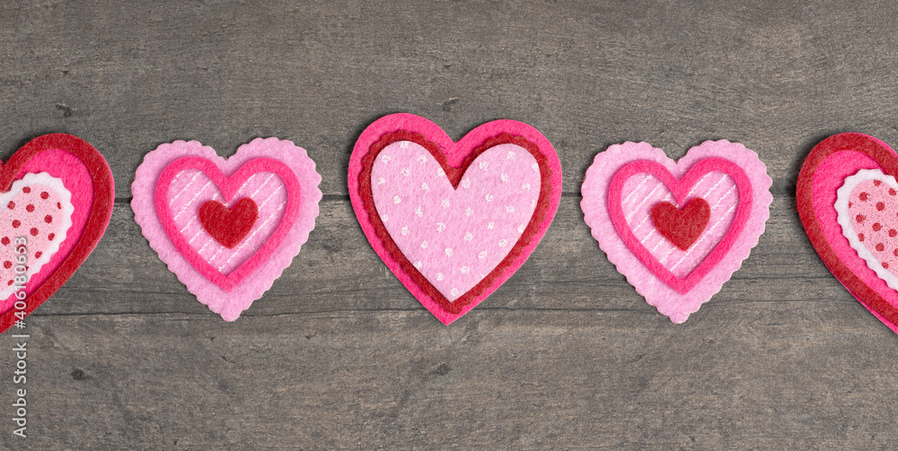 Simple Background with Felt Love Hearts on a Wood Table Simple Background with Felt Love Hearts on a Wood Table