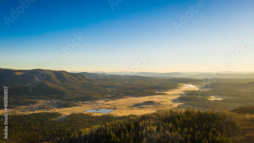 An aerial image of a mountain valley in the early morning light.
