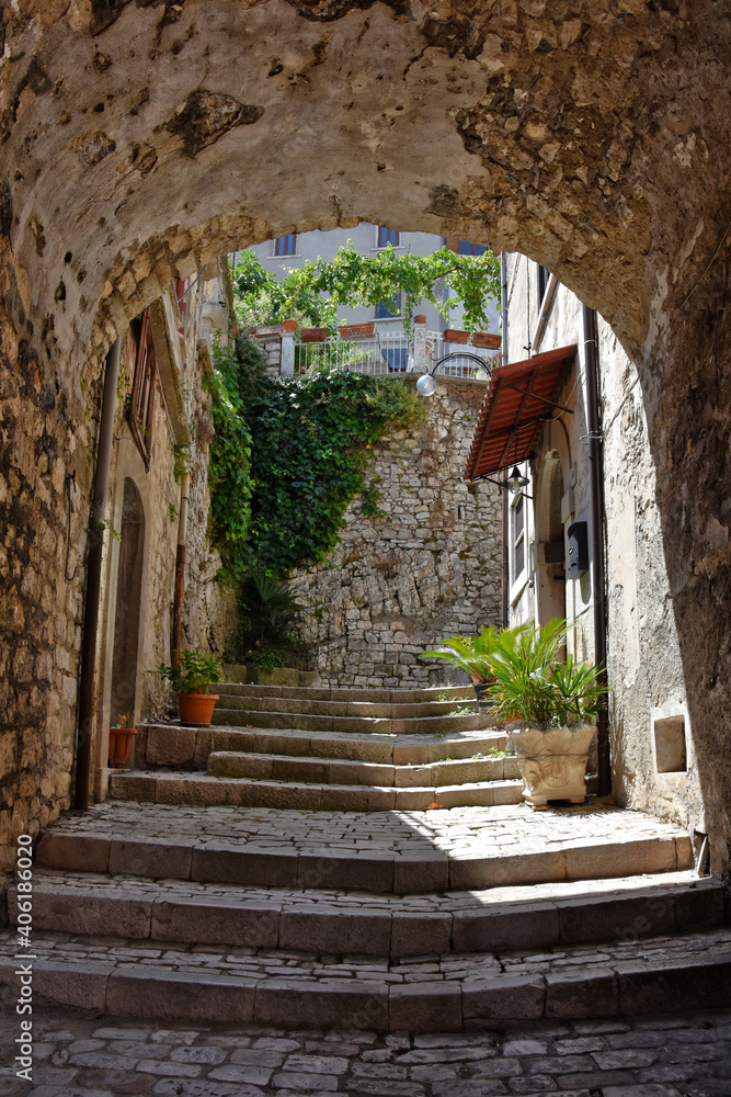Fototapeta premium An entrance arch in one of the alleys in the medieval town of Morcone in the province of Benevento.