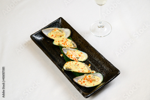 Oysters with red caviar on white background