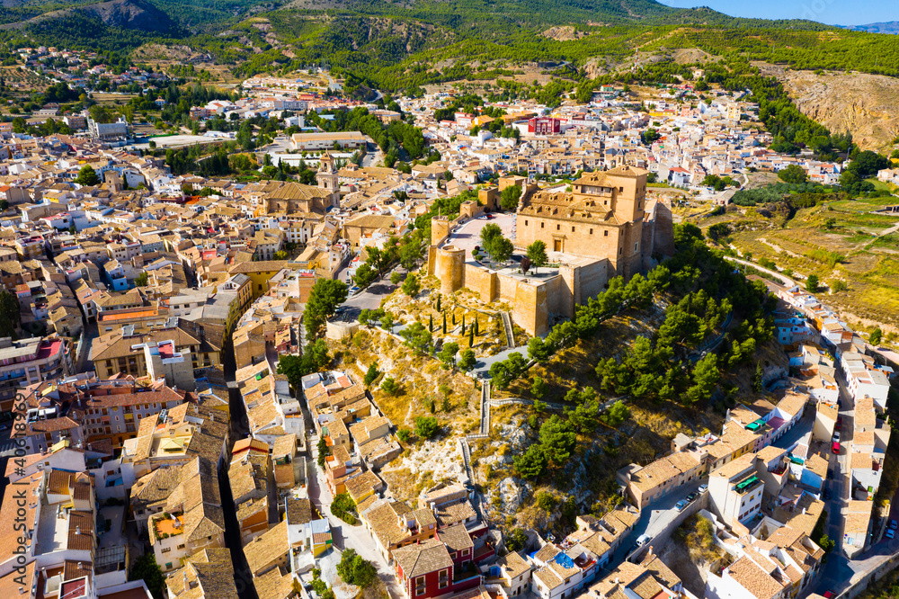 Aerial view of Caravaca de la Cruz cityscape with ancient fortified castle and Roman Catholic church, Spain