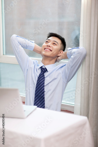 Portrait of a young bisiness man sthetching photo