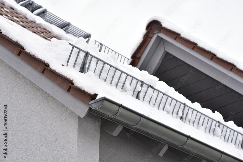 Obraz premium Schneefanggitter zur Vermeidung von Dachlawinen auf einem Ziegeldach montiert