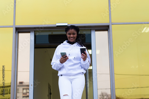 happy African American woman coming out of the business center