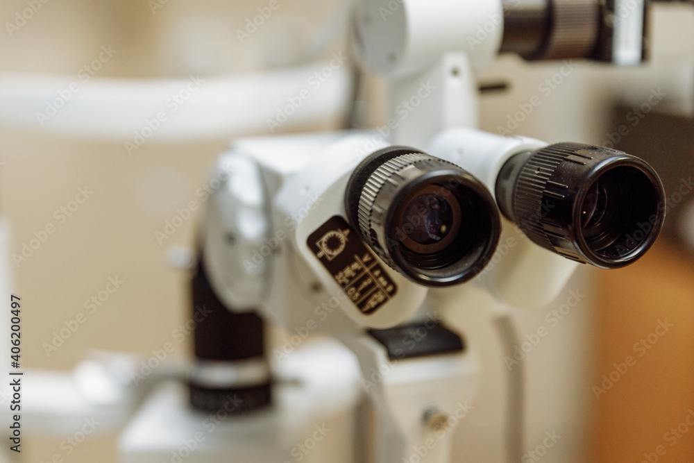 View of the ophthalmic microscope on the table in the ophthalmologist's office. Modern diagnostics and treatment of vision. Diagnostic microscopic medical equipment. View of the ophthalmic microscope on the table in the ophthalmologist's office. Modern diagnostics and treatment of vision. Diagnostic microscopic medical equipment.