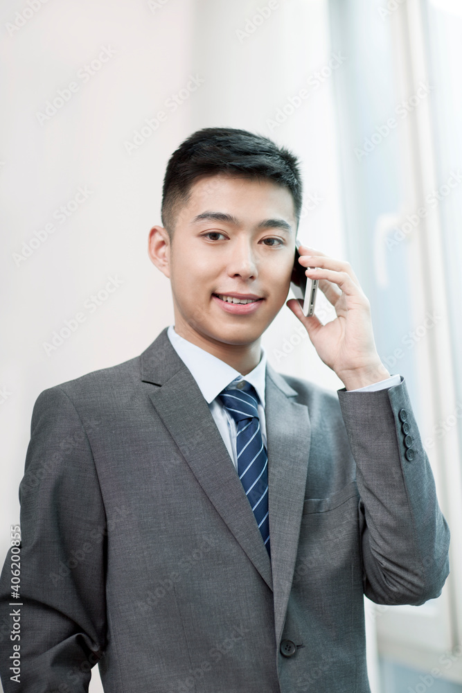 Portrait of young bisinessman talking on cell phone Portrait of young bisinessman talking on cell phone