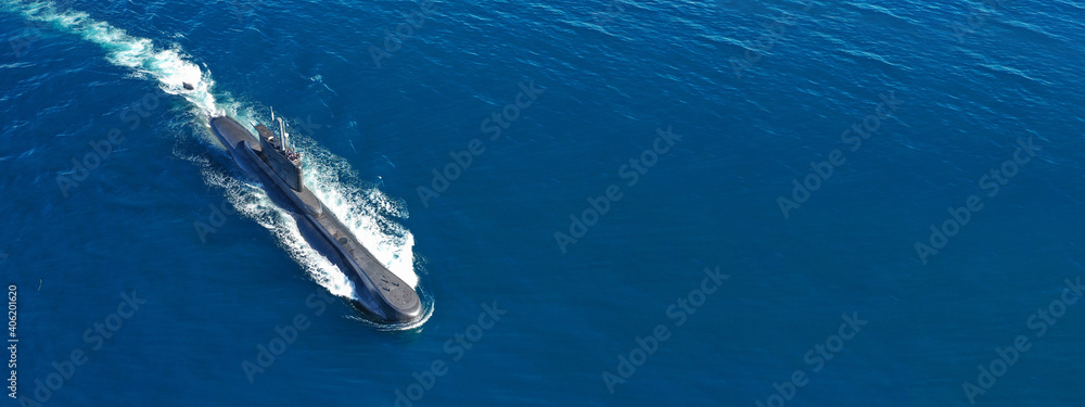 Aerial drone ultra wide panoramic photo of latest technology armed diesel powered submarine cruising half submerged