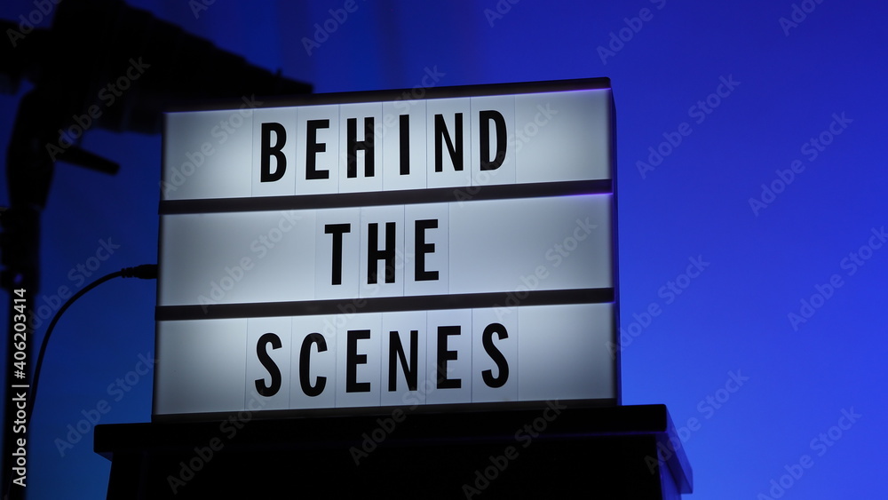 Cinema Light box. Behind the scenes letterboard text on Lightbox. Multi color LED on background. Sillhouette flash snoot hood on tripod. video production studio. Behind the scene Lightbox Cinema Light box. Behind the scenes letterboard text on Lightbox. Multi color LED on background. Sillhouette flash snoot hood on tripod. video production studio. Behind the scene Lightbox