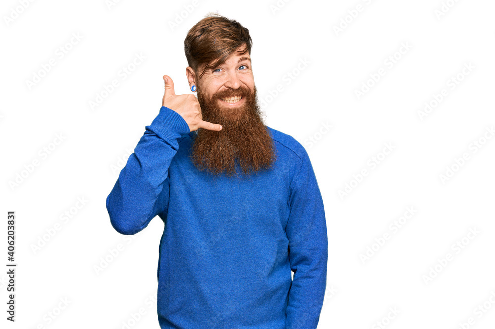 Young irish redhead man wearing casual clothes smiling doing phone gesture with hand and fingers like talking on the telephone. communicating concepts.