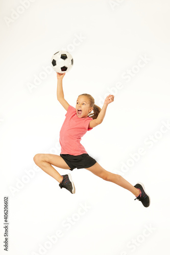 Cute girl with soccer ball jumping and screaming © Friends Stock