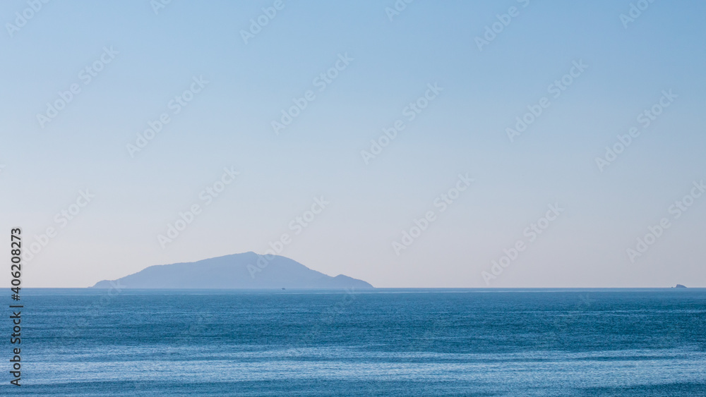 island in the ocean  located at Quatro Ilhas Beach, Bombinhas, Santa Catarina, Brazil